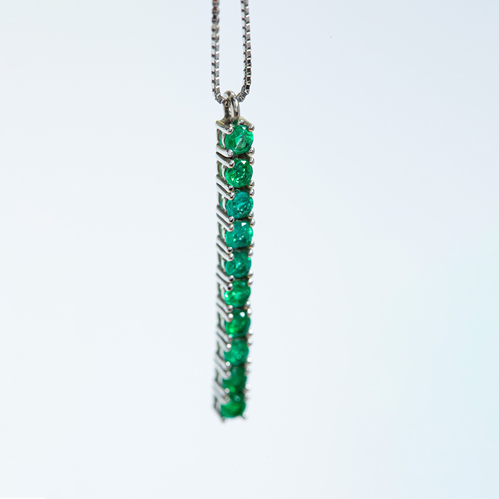 Gold Colombian emerald and diamond pendant necklace by Smeralco, luxury tennis design for Miami Bar Association and legal professionals.