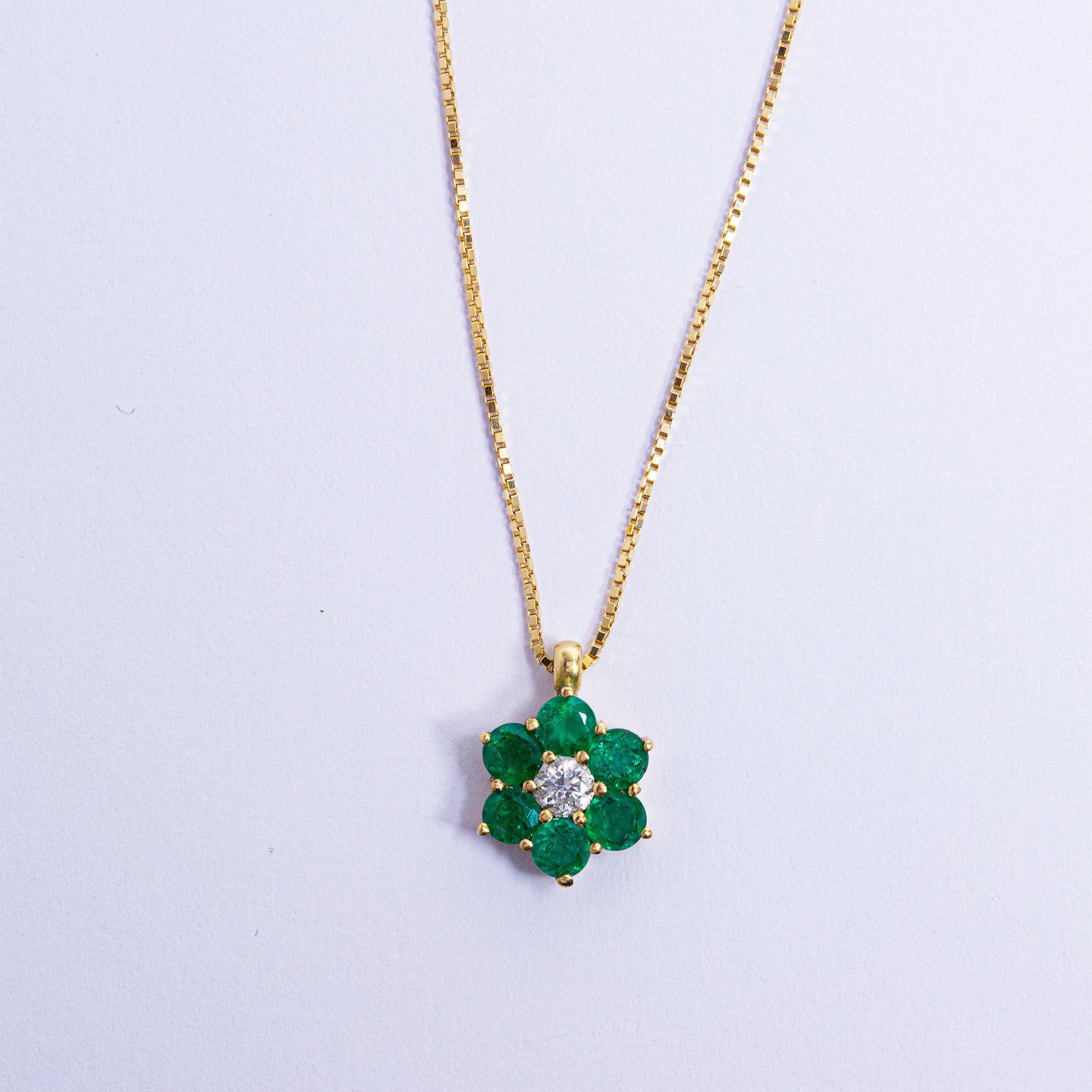 Gold Colombian emerald and diamond pendant necklace by Smeralco, elevating the look with exclusivity and luxury, for an event at Wimbledon, London. Exclusive luxury jewelry